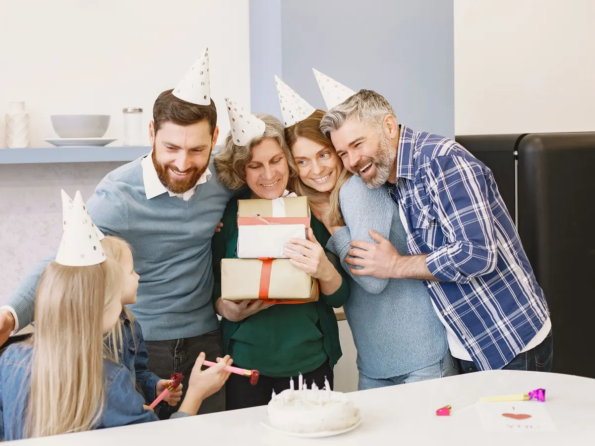 Friends hugging a birthday girl the moment she arrives